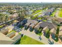 An elevated aerial view captures townhomes with green lawns, landscaping, and brick driveways at 114 Tuscany Villas Dr, Edgewater, FL 32141