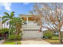 Charming two-story home featuring a spacious garage, brick driveway, and a welcoming American flag at 1432 Titian Ct, Reunion, FL 34747
