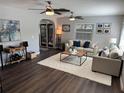 Bright living room features wood floors, ceiling fans, and a neutral color scheme at 2909 Depauw Ave, Orlando, FL 32804