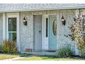 Close up shot of a stone exterior with a light blue front door at 3117 Lake Mar Ln, Orlando, FL 32806