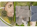 Aerial view of home showcasing its layout, roof, and adjacent playground at 619 Oxford Chase Dr, Winter Garden, FL 34787