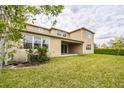 Expansive backyard with lush lawn and a covered patio, perfect for outdoor enjoyment at 619 Oxford Chase Dr, Winter Garden, FL 34787