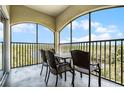 Enjoy the outdoor space with a view from this condo's screened balcony with table and chairs at 8762 Worldquest Blvd # 6506, Orlando, FL 32821