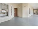 Hallway featuring stylish lighting fixtures, neutral paint and trim, and several large windows at 8762 Worldquest Blvd # 6506, Orlando, FL 32821