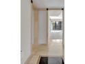 A foyer with stone tile flooring leading into a sunlit living space at 100 S Interlachen Ave # 304, Winter Park, FL 32789