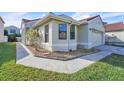 Exterior view of a home with a red tile roof, showcasing well-kept landscaping and a concrete walkway at 1008 Birkdale Trl, Winter Springs, FL 32708