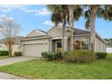 Well-maintained home with a two-car garage, nicely landscaped front yard and a beautiful shade tree at 105 Adoncia Way, Sanford, FL 32771