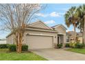 Inviting home with manicured lawn, a two-car garage and stone accents at 105 Adoncia Way, Sanford, FL 32771