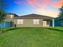 Spacious backyard with lush green grass, offering a private outdoor space with sliding glass door access to the home at 1133 August Sky Dr, Deltona, FL 32738