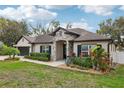 Charming single-story home featuring a stone entryway, well-manicured landscaping, and a two-car garage at 1222 Shorecrest Cir, Clermont, FL 34711