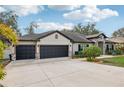 Three car garage on this lovely home with mature landscaping and beautiful curb appeal at 1222 Shorecrest Cir, Clermont, FL 34711
