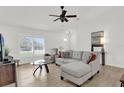 Bright living room featuring wood-look floors and a comfortable sectional sofa at 15697 Sw 37Th Cir, Ocala, FL 34473