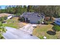 Aerial view of a single-story home showcasing the surrounding neighborhood and landscaping at 16 Cedar Dr, Davenport, FL 33837