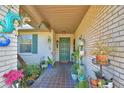 View of front door, adorned with many plants and decorations at 16 Cedar Dr, Davenport, FL 33837
