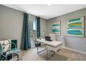 Bright home office featuring a contemporary desk, modern decor, and a large window with bright natural light at 1736 Three Bars Rd, Kissimmee, FL 34744