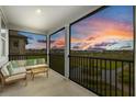 Relaxing screened porch with comfortable seating and a beautiful outdoor view at 1763 White Feather Loop, Oakland, FL 34787