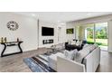 Open living room with modern furnishings, stylish rug, and sliding glass doors to the backyard at 2160 7Th Ave, Deland, FL 32724