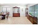 Dining room with elegant wood furniture and bright natural light from large windows at 2805 Polson Dr, Kissimmee, FL 34758