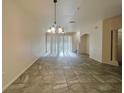 Open-concept living space with tile flooring and natural light at 2946 Ashland S Ln, Kissimmee, FL 34741