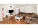 A cozy living room with hardwood floors, a comfortable couch, and a large television at 432 Wilderness Dr, Longwood, FL 32779