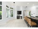 Sun-drenched breakfast nook with a desk and island seating at 5138 Fairway Oaks Dr, Windermere, FL 34786