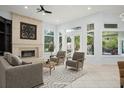 Bright living room with fireplace, neutral furniture, and views of the pool at 5138 Fairway Oaks Dr, Windermere, FL 34786