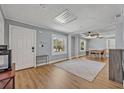 Bright living room with hardwood floors, neutral paint, and view to dining area at 525 S Crystal Lake Dr, Orlando, FL 32803