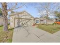 Suburban home showing a two-car garage, driveway and manicured lawn with minimal landscaping at 615 Blue Park Rd, Orange City, FL 32763