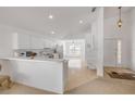 Bright, open kitchen featuring white cabinetry, modern appliances, and seamless access to the living areas at 615 Blue Park Rd, Orange City, FL 32763