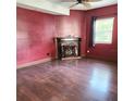 Cozy living room featuring hardwood floors and a decorative fireplace at 615 S Laurel Ave, Sanford, FL 32771