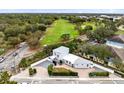 Aerial view of a modern white home near a golf course with mature landscaping at 726/720 N Pennsylvania Ave, Winter Park, FL 32789