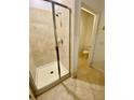 Bathroom with a glass-enclosed shower stall with tile surround and separate toilet area at 7681 Fordson Ln, Windermere, FL 34786