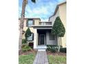 Charming townhome featuring a covered front porch and neatly manicured landscaping at 7681 Fordson Ln, Windermere, FL 34786