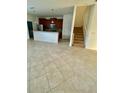 Open-concept living area with tile flooring that flows into adjacent kitchen area at 7681 Fordson Ln, Windermere, FL 34786