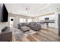 Open living space with a comfortable sectional sofa, kitchen, and a dining area at 1965 3Rd Dr, Sanford, FL 32771