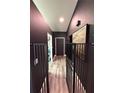 Hallway with luxury vinyl flooring, wainscoting and pet gate, providing safety and style at 2652 Graduate Ct, Orlando, FL 32826