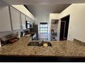 Modern kitchen featuring granite countertops, stainless steel appliances, and ample storage at 2652 Graduate Ct, Orlando, FL 32826