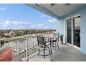 Enjoy serene water views from this condo balcony, with seating for relaxing and entertaining outdoors at 3 Riverwalk Dr # 506, New Smyrna Beach, FL 32169