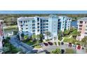 Condo building with landscaped grounds, dedicated parking, and inviting exterior design at 3 Riverwalk Dr # 506, New Smyrna Beach, FL 32169