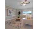 Bright living room with a decorative rug, modern furniture, and a sliding glass door with a lake view at 3969 Southern Vista Loop, St Cloud, FL 34772