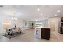 Bright, open-concept living area with tile floors, adjacent to the kitchen and dining spaces at 3969 Southern Vista Loop, St Cloud, FL 34772