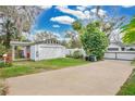 Detached garage with lovely lawn, driveway, and beautiful mature trees at 4522 Flagg St, Orlando, FL 32812
