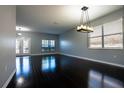 Open concept living space featuring dark wood floors, pendant lighting, and a window at 535 Belle Fern Ct, Ocoee, FL 34761