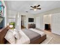 Comfortable bedroom with a ceiling fan, TV, dresser, and a view into the bathroom and closet at 5825 Hafer Ln, Orlando, FL 32808