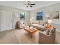 Bright living room with neutral walls, plush seating, and a ceiling fan at 5825 Hafer Ln, Orlando, FL 32808