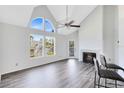 Bright living room with a high ceiling, fireplace, and large windows at 6178 Westgate Dr # 304, Orlando, FL 32835