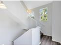 Bright staircase features dark wood floors and natural lighting at 6178 Westgate Dr # 304, Orlando, FL 32835