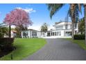 Elegant modern home with a circular driveway and lush green lawn at 641 Lake Catherine Dr, Maitland, FL 32751