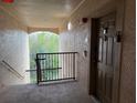 Condo hallway leading to unit entrance with outdoor view and natural light at 8000 Tuscany Way # 4405, Davenport, FL 33896