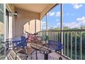 Relaxing screened condo patio with seating, table and pretty outdoor view at 8000 Tuscany Way # 4405, Davenport, FL 33896
